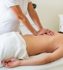 Fototapeta na wymiar Massaging a woman in the spa