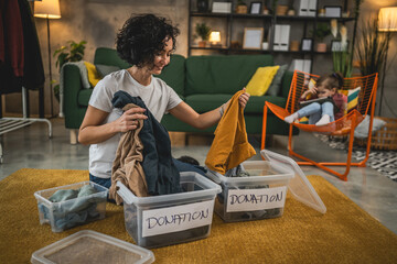 Adult caucasian woman at home sorting clothes wardrobe for donation