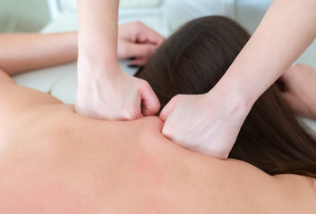 Fototapeta na wymiar Massaging the neck of a woman