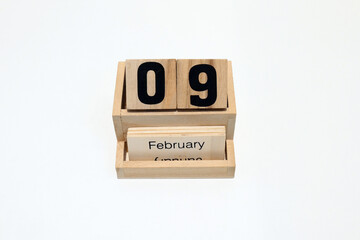 9th of February wooden perpetual calendar. Shot close up isolated on a white background 