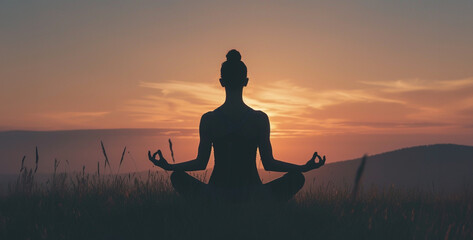Yoga woman in lotus pose on top of mountain at sunset,Silhouette of woman practicing yoga in the lotus position at sunset