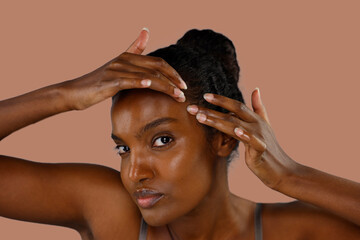 black young woman doing DIY face massage for skin rejuvenation