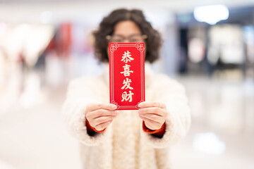 Hand holding Spring Festival red envelope