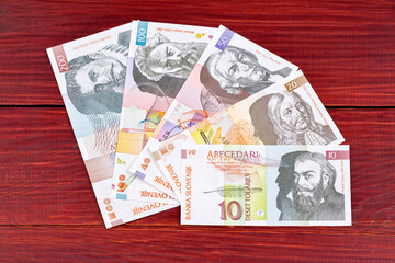 Slovenian money - Tolar on a wooden background