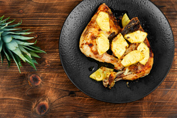 Chicken baked served with pineapple.