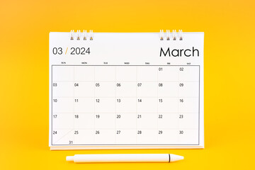 March 2024, Monthly desk calendar for 2024 year and pen on yellow background. - obrazy, fototapety, plakaty