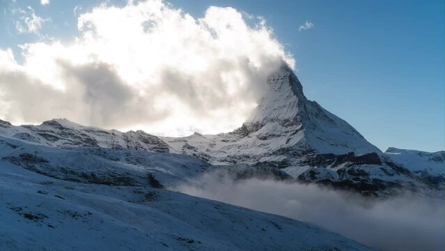 Timelapse far away Zermatt clear Matterhorn Switzerland  glacier paradise The Gornergrat Lake Riffelsee view Swiss alps autumn winter Christmas first snow late afternoon blue golden dramatic landscape
