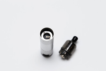 Opened vaping device, vape, pod, kit silver color on white background, top view
