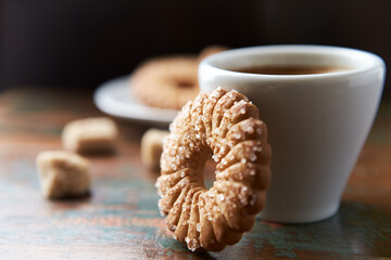 Butter cookie and a cup of Coffee on rustic wooden background. Close up.	