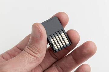 modern handheld game cartridge in hand close-up