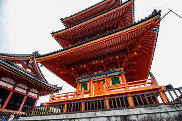 Fototapeta na wymiar View from below, close-up of the ancient famous Orange Temple in the hills of Kyoto, Japan, horizontal image. Japanese historical and spiritual sites. 