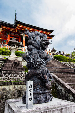 Close-up on a dragon statue at the entrance of a Japanese temple in Kyoto, Japan. Vertical image of architectural beauty, culture experience and historical treasure.