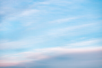 Obraz premium A beautiful sky tinted by the sun leaving vibrant shades of gold, pink, blue and multicolored. Clouds in the twilight evening and morning sky. Cloudy sky background in the evening and during the day.