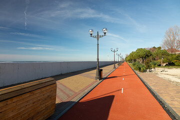 promenade of the resort town along the sea with a pedestrian and bicycle path with a beautiful...