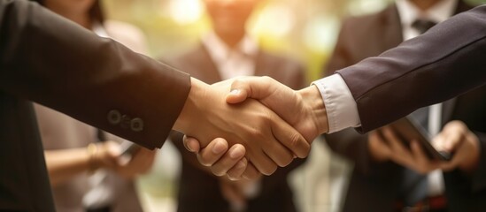 Business individuals joining hands in a firm handshake, signifying completion of vision and mission. Working together towards shared goals for unity and success.