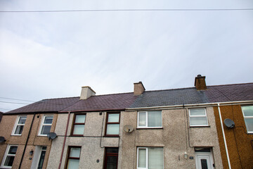 Group of houses with a view of the facade with windows and roof under a blue sky