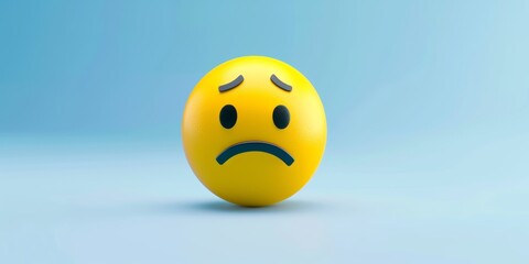 Blue Monday concept. Yellow sad emoji face on light blue background