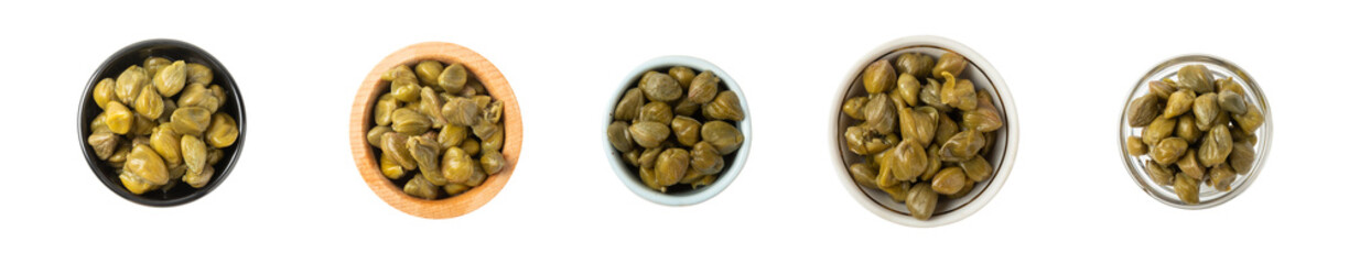 Capers in a bowl isolated on a white background. Marinated caper buds, small salted capparis in...