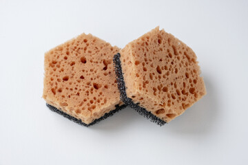 Two new foam sponges with a black abrasive layer for cleaning dishes and removing dirt