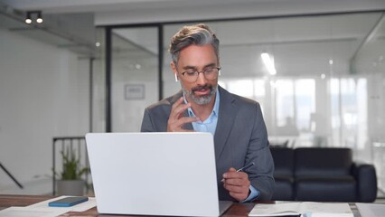 Middle-age Hispanic man using computer remote for business studying, watch online virtual webinar training meeting, video call. Smiling mature Indian or Latin businessman working on laptop in office.