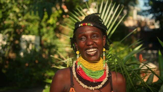 Joyful African Woman Grinning While Adorned in Traditional Attire, in Uganda, East Africa - Close Up