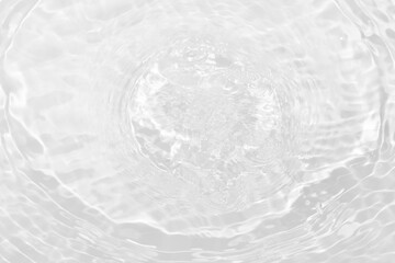 White water with ripples on the surface. Defocus blurred transparent white colored clear calm water surface texture with splashes and bubbles. Water waves with shining pattern texture background.