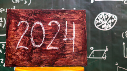 The inscription in chalk 2024 on the background  school board, problems goals and objectives for...