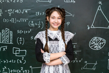 Teenage girl near school board portrait of student 12-14 years old.
