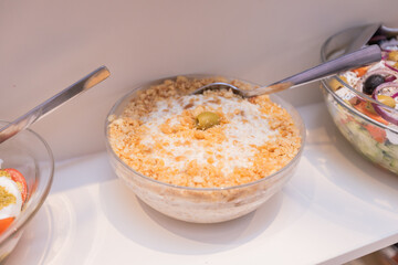 Bowl of creamy potato salad topped with crispy croutons, ready to be served.