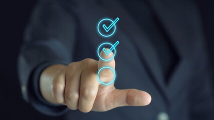Businessman's hand touching correct glowing sign for document approval and project approval concept with copy space.