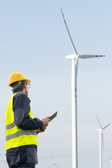 Engineer with tablet computer on a background of wind turbines