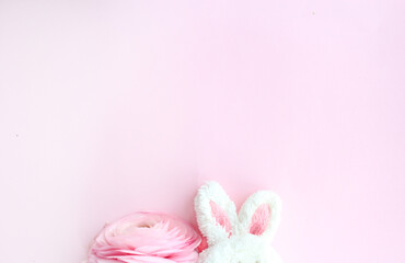 Peekaboo Bunny: A Delightful Close-Up of a Plush Toy Bunny and a Beautiful Pink Flower