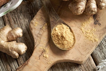 Ginger powder and fresh root on a table
