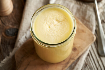 A jar of ghee or clarified butter on a table