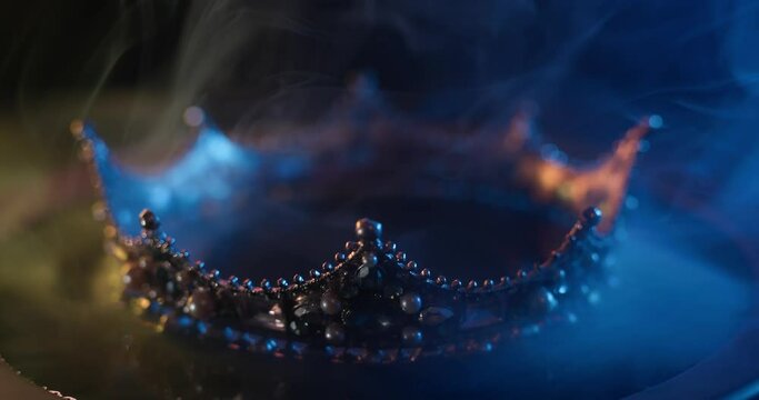 Fabulous golden crown of the king on a dark background. Panoramic view of the fog. Mockup for your logo.