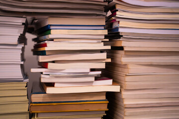 Stacks of large books piled high on top of each other