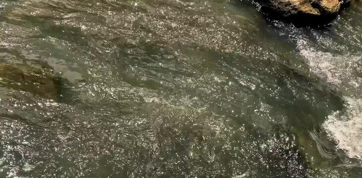 clear river in an unspoiled mountain area with rocks and fast flowing water