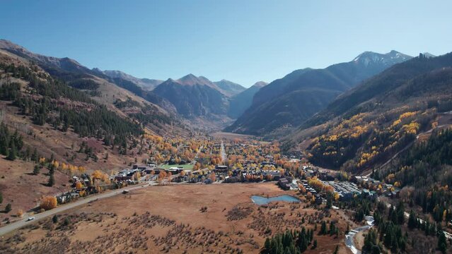 Distant drone aerial view over telluride, CO city in the fall on a sunny day