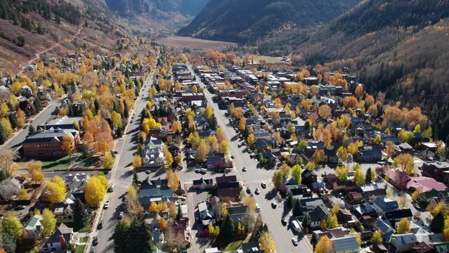 Pullback drone shot over main street in telluride, CO with fall colors