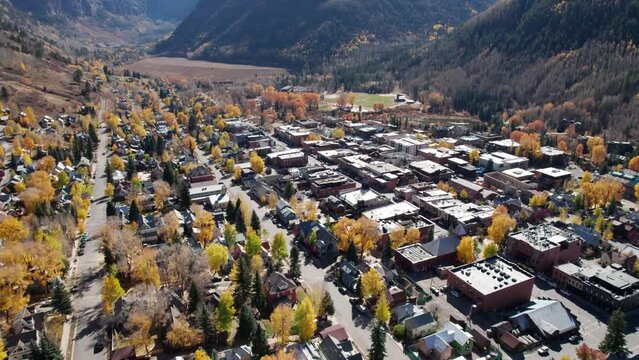 Drone shot swooping in over the town of Telluride, CO with the fall colors