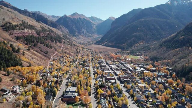 Pullback drone shot over downtown Telluride, CO on a sunny day in the fall