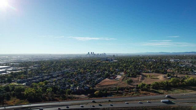 Drone shot rising up over a highway outside of Denver, CO on a sunny fall day