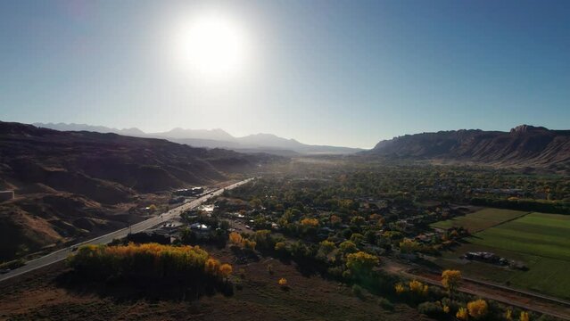 Drone shot flying south over Moab, Utah in the morning with fog haze