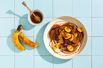 Banana pancakes with honey and fresh bananas.
