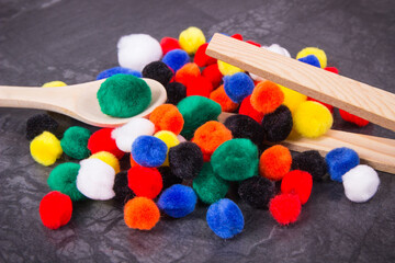 Colorful pompoms using for development of kids motor skills, coordination and logical thinking