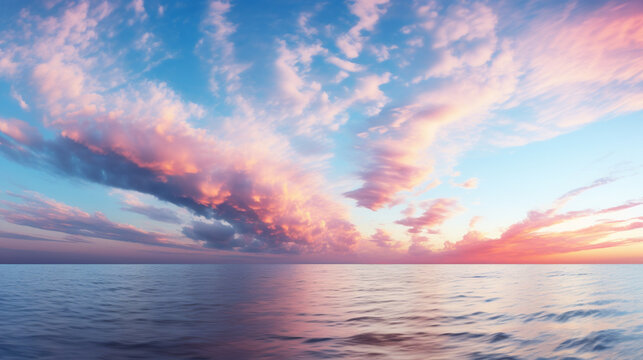 Cirrus clouds tinted pink by the sun at sunset over a calm blue ocean © Farid