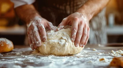 Fotobehang man's hands knead the dough for baking bread in the bakery © sergiokat