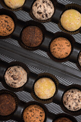 Chocolates in a box on a black background. Top view.