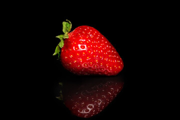 Fresh organic bright red strawberries on a black background. Fresh berry