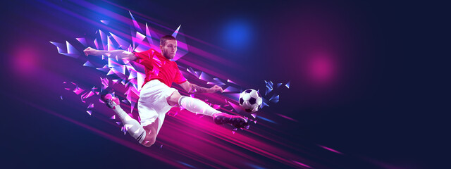 Banner. Athletic man, professional soccer player scores goal against gradient background with...